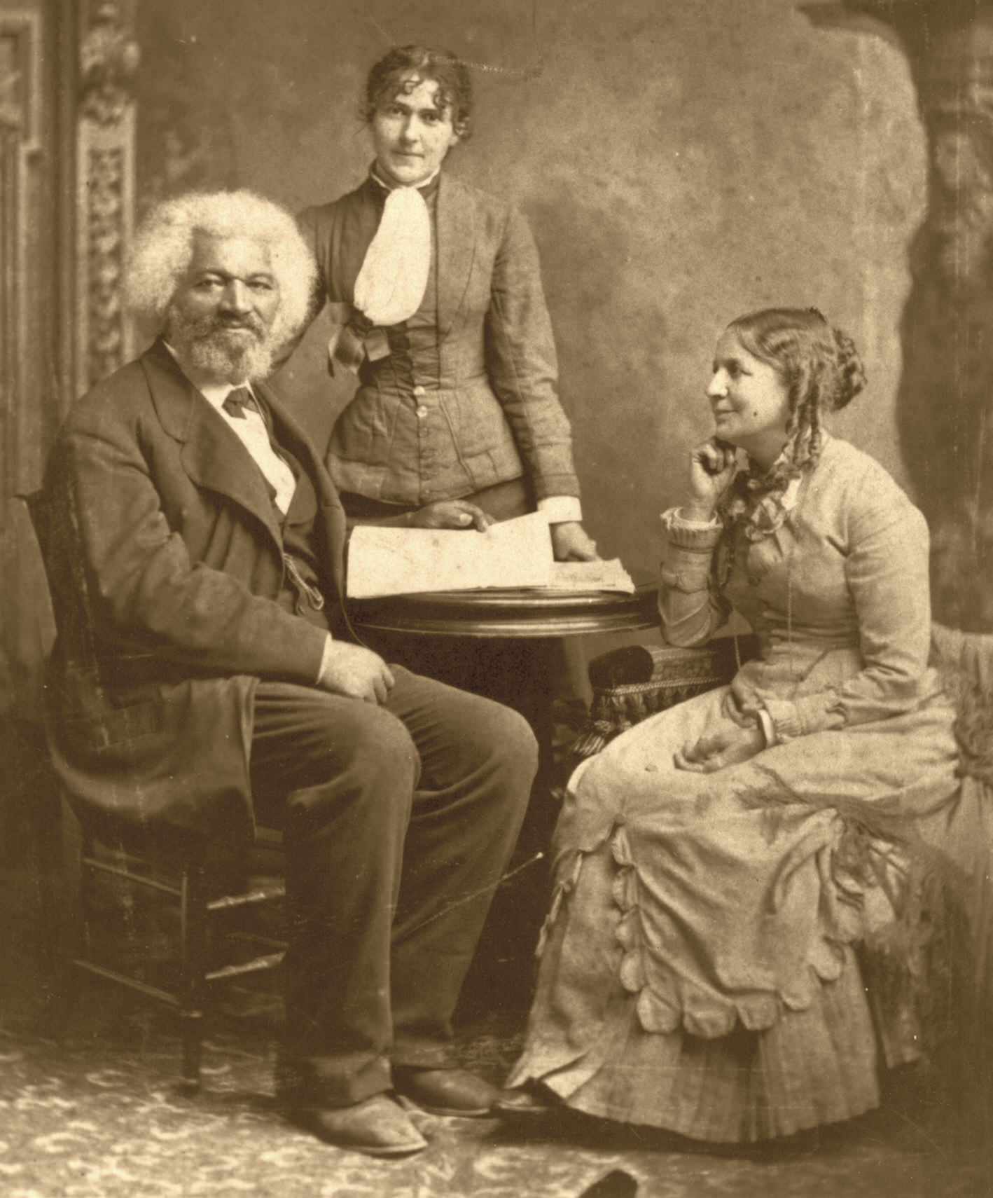Frederick Douglass after 1884 with his second wife Helen Pitts Douglass (sitting). The woman standing is her sister Eva Pitts.