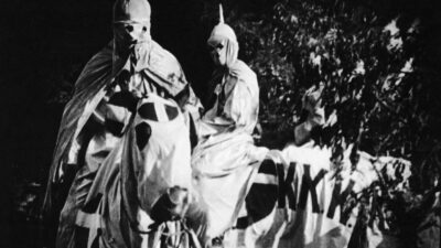 Actors dressed in ku klux klan costumes in a scene from the film the birth of a nation