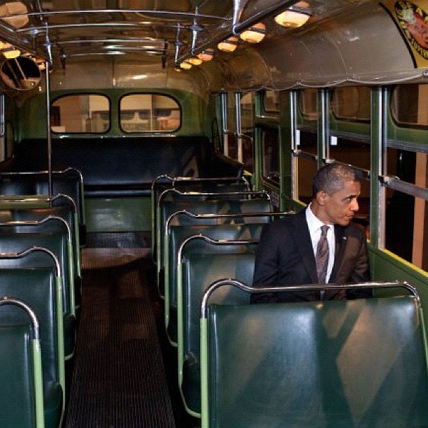 President Obama sitting in the famous Rosa Parks bus seat