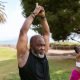 Healthy living an elderly man in black tank top raising his hands together