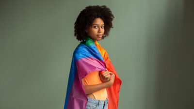 rainbow flag wrapped around woman
